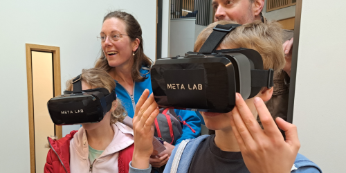 Two kids wearing VR head mount and their parents in the background