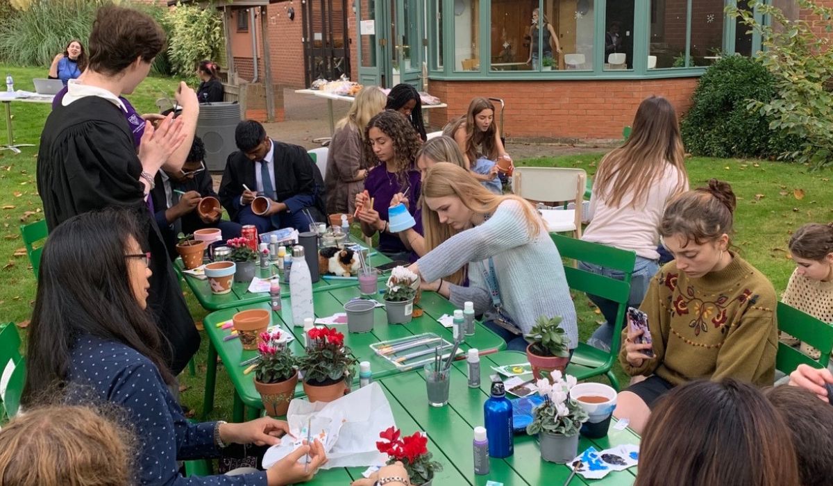 Students at plant potting activity in College gardens