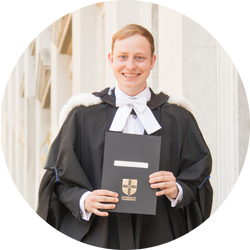 Luke holding graduation certificate