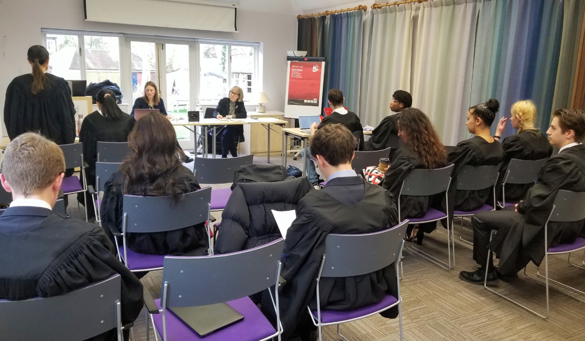 Student arguing case in front of peer