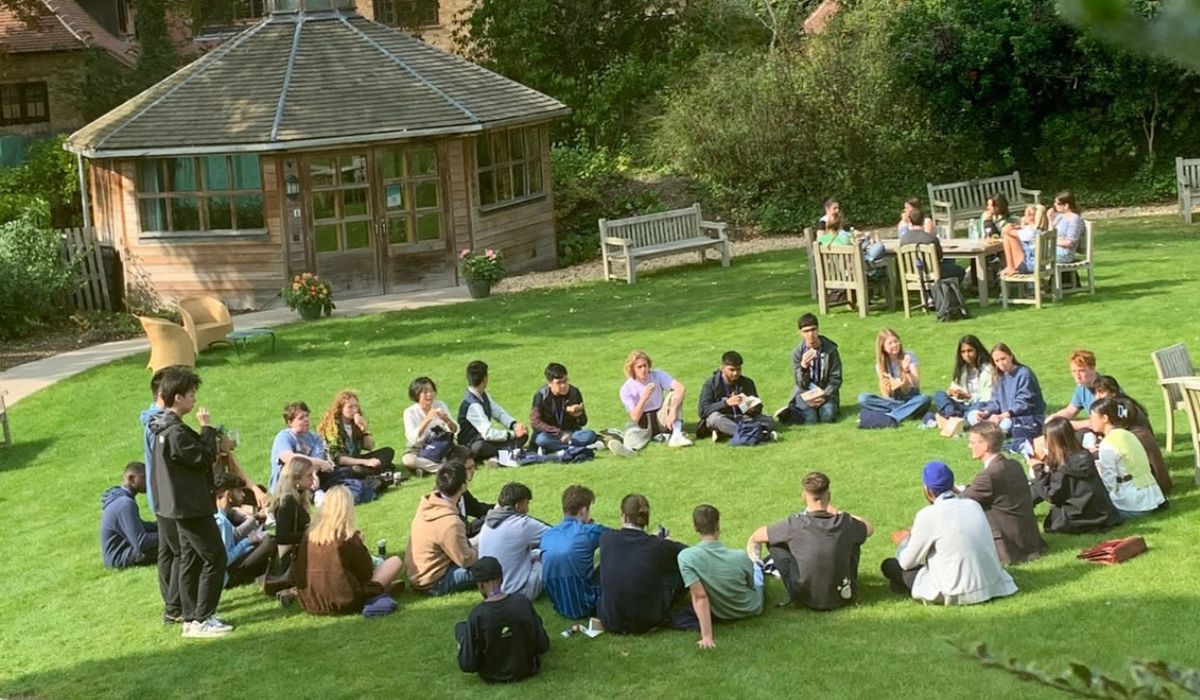 Group of students sitting in a circle on Strathaird lawn