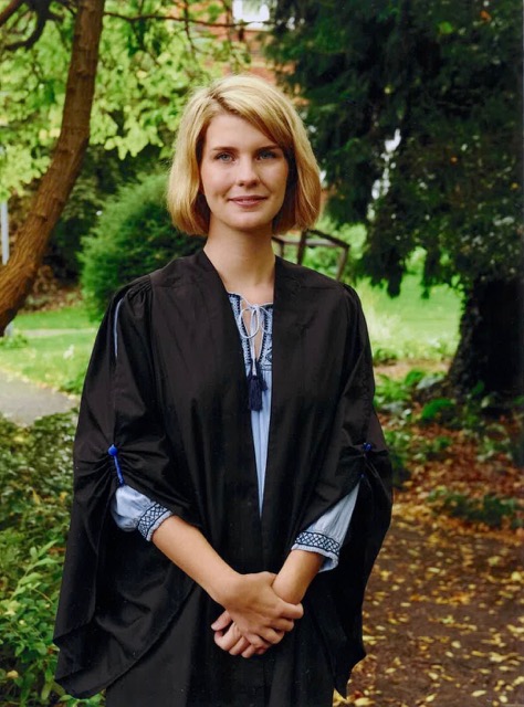 Ellen Verde in garden wearing gown