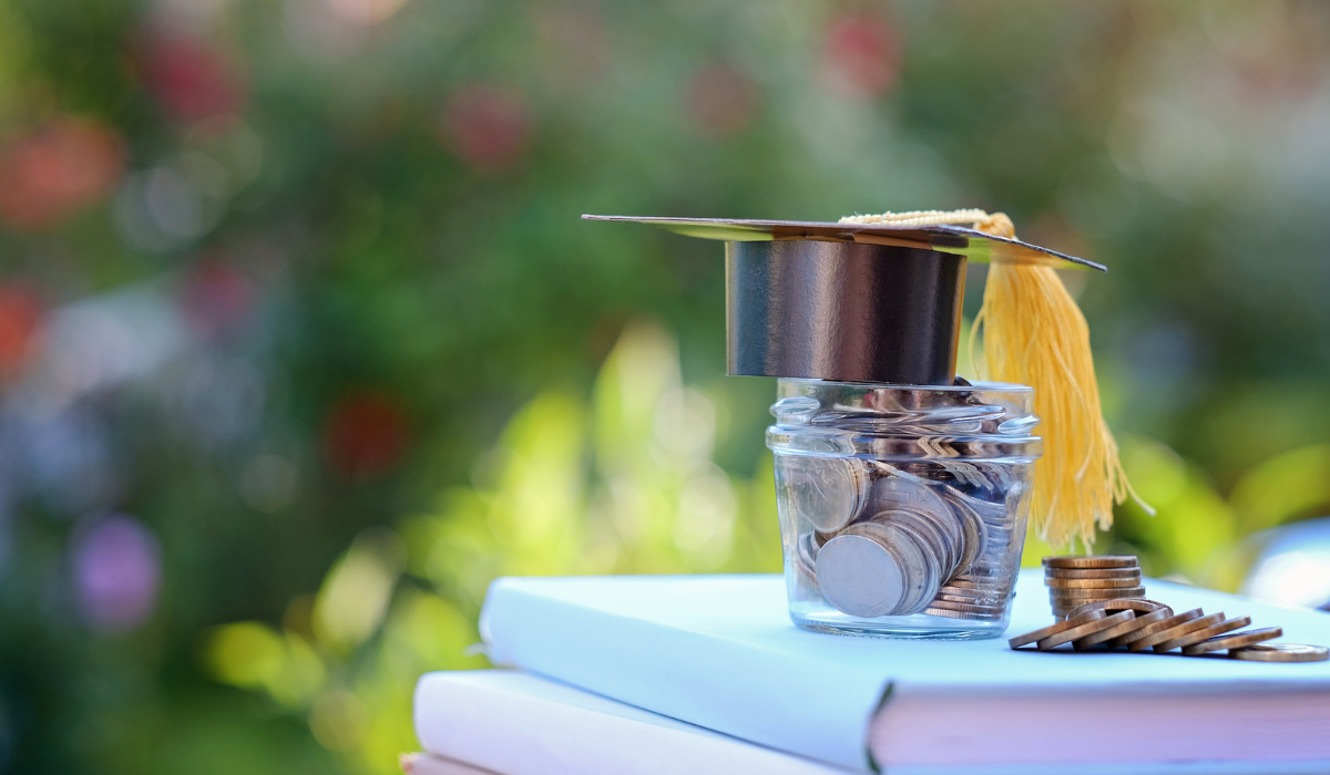 Coins, books and graduation hat