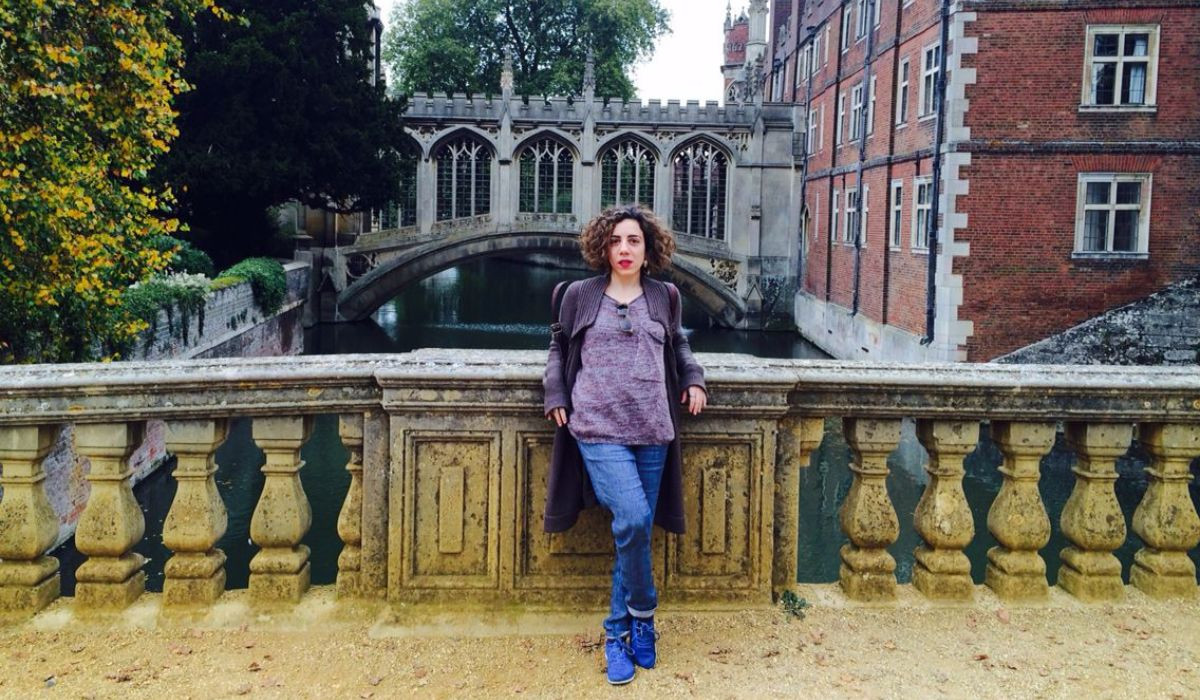 Zoe Angeli standing on St Johns College bridge with Bridge of Sighs in the background