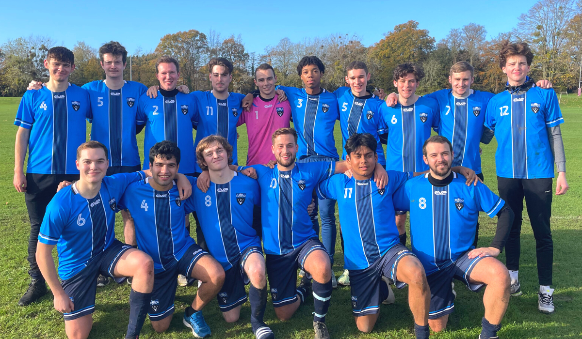 Outdoors on the pitch, a team photo of the Lucy Cavendish College Football Team
