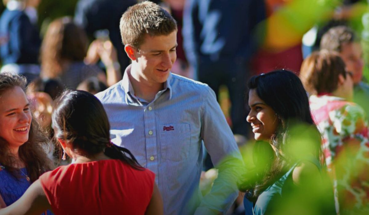 Four people standing and chatting