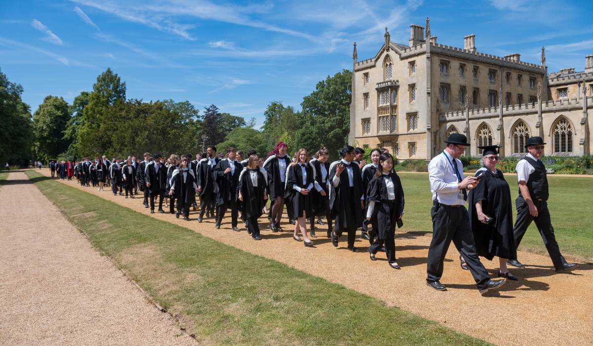 Graduation procession led by porters and praelector going through St John's grounds