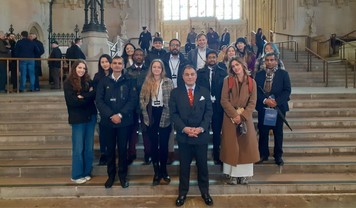 Lucy students and Lord Bilimoria standing on steps at UK Parliament