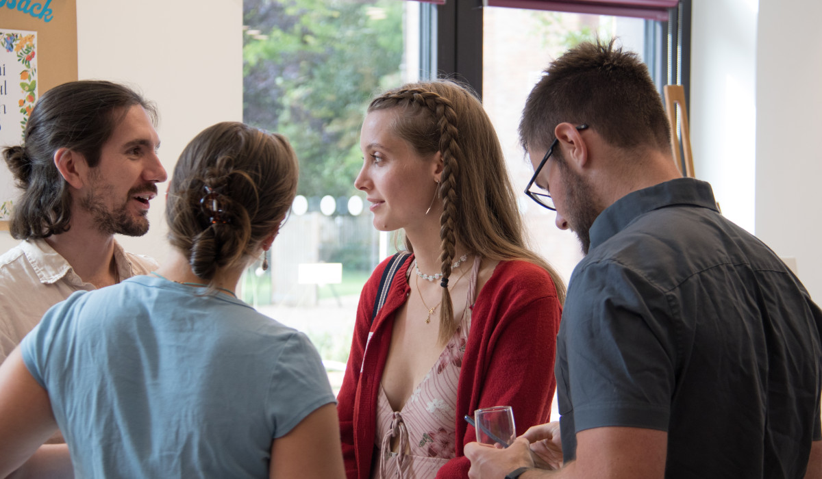 four alumni chatting