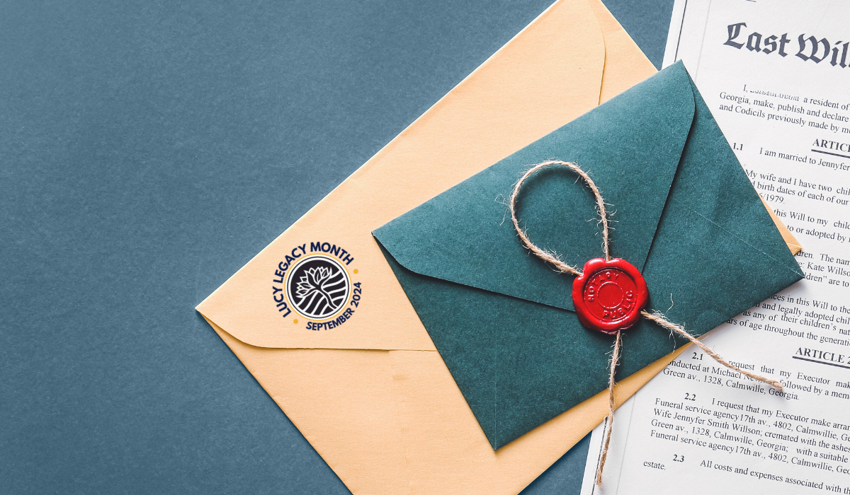 A sealed, dark green envelope with a red wax seal lies atop a beige envelope bearing a "Legacy Month September 2024" logo. A portion of a Last Will and Testament document is visible, detailing funeral arrangements and the testator's children.