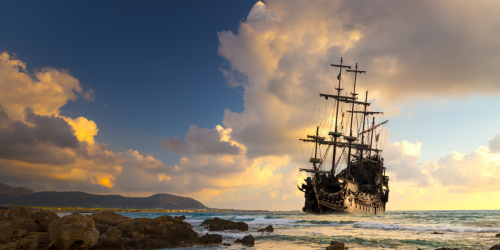 Pirate ship sailing at sunset