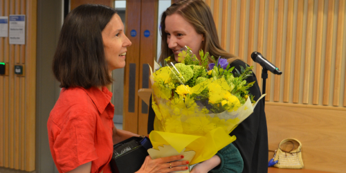 Clair receiving flowers at the award ceremony