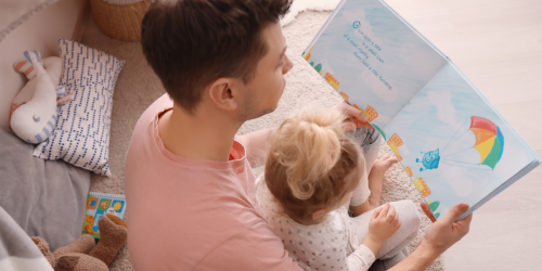 Father and daughter reading story book