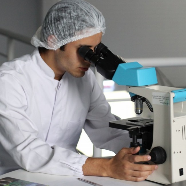 men in lab using microscope